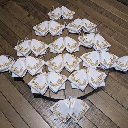 White mariachi monos with gold embroidered floral design