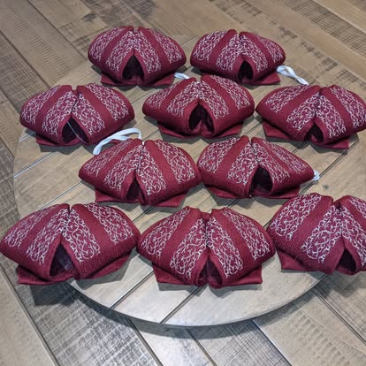 Burgundy mariachi monos with silver embroidered stripe pattern