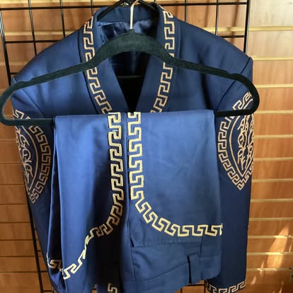 Navy blue mariachi traje suit with gold Greek key embroidery on jacket and pants