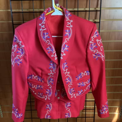 Red mariachi traje jacket with colorful blue and pink floral embroidery