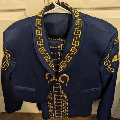 Navy blue mariachi traje jacket with gold Greek key border and gold chain botonadura