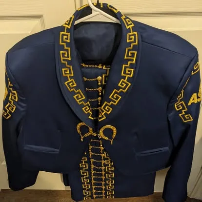 Navy blue mariachi traje jacket with gold Greek key border and gold chain botonadura